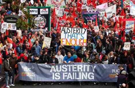 Demonstrators hold placards before the start of a protest march, on the embankment, in central London October 20, 2012. Thousands of anti-austerity protesters marched in London on Saturday to protest against public spending cuts enacted by a government fighting off accusations that it is run by an upper-class elite that ignores the plight of recession-hit voters. REUTERS/Suzanne Plunkett (BRITAIN - Tags: BUSINESS POLITICS EMPLOYMENT TPX IMAGES OF THE DAY)